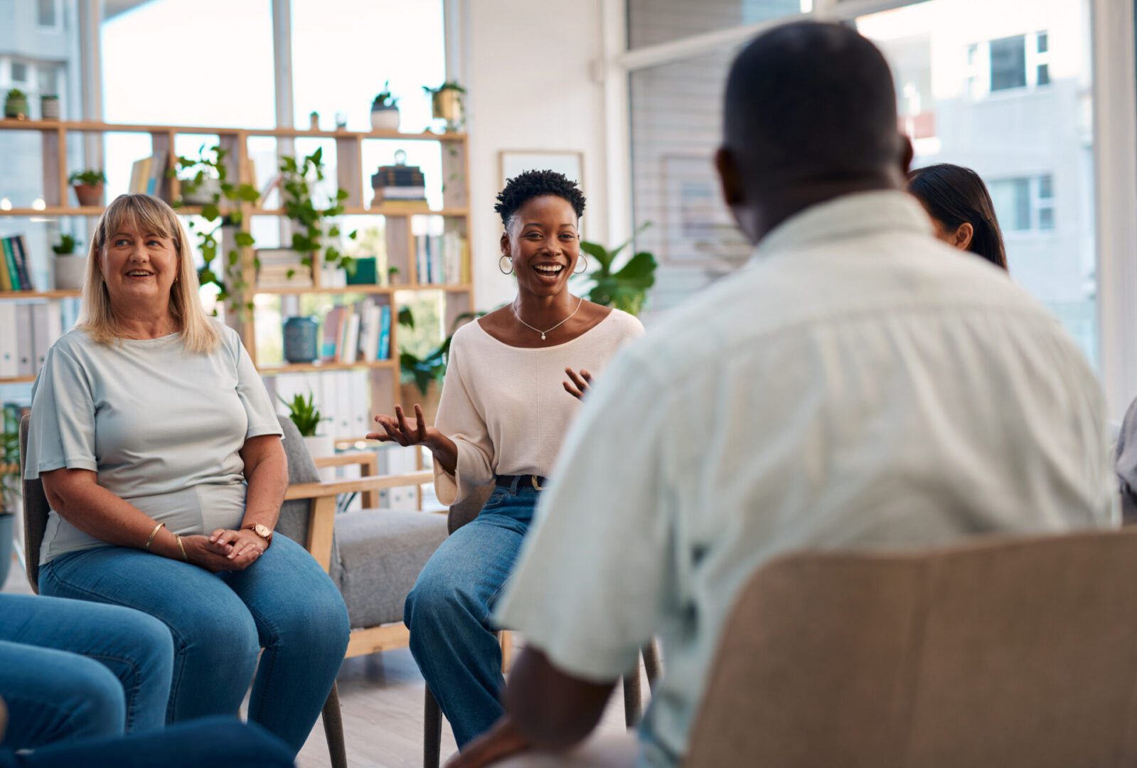 Group therapy session with people sharing experiences.