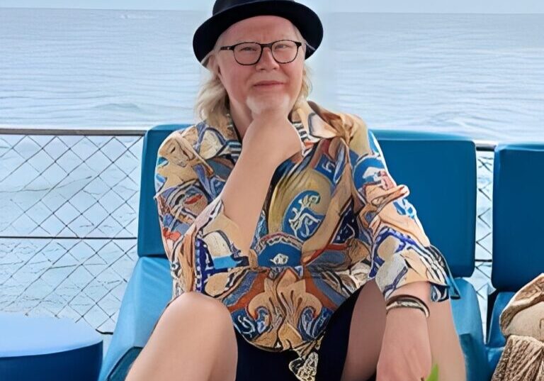 Person relaxing on a boat with flowers.